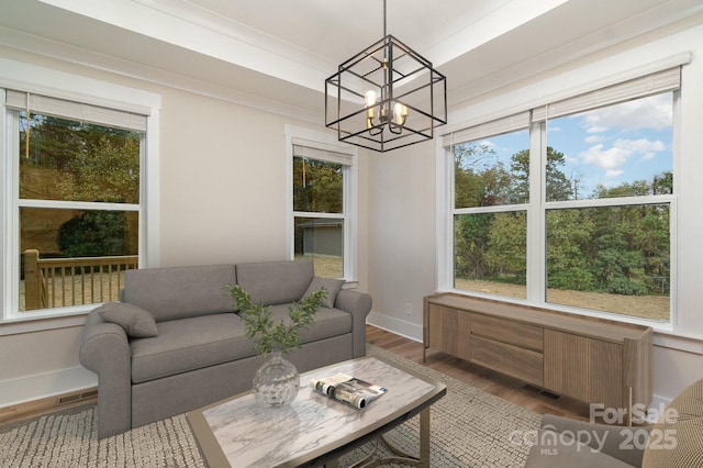 sunroom / solarium with an inviting chandelier