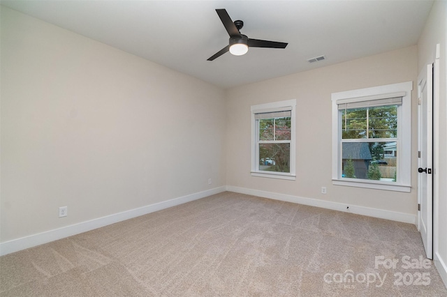 carpeted empty room featuring ceiling fan