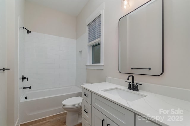 full bathroom with washtub / shower combination, toilet, wood-type flooring, and vanity