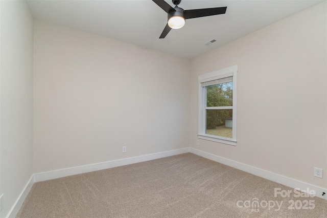 spare room with ceiling fan and carpet