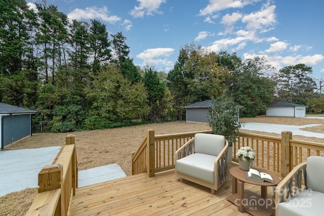 wooden deck with a garage and an outdoor structure