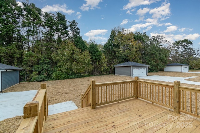 deck featuring a garage and an outbuilding