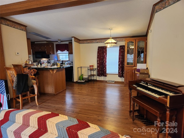 interior space with ornamental molding, dark wood-type flooring, and a textured ceiling