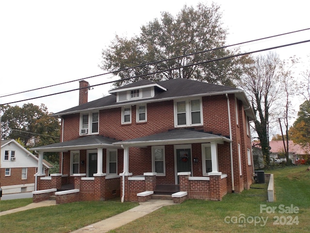 view of front of house featuring central AC unit, a porch, and a front lawn