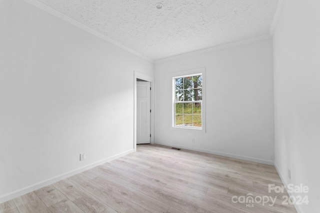 unfurnished room with light hardwood / wood-style floors, a textured ceiling, and ornamental molding