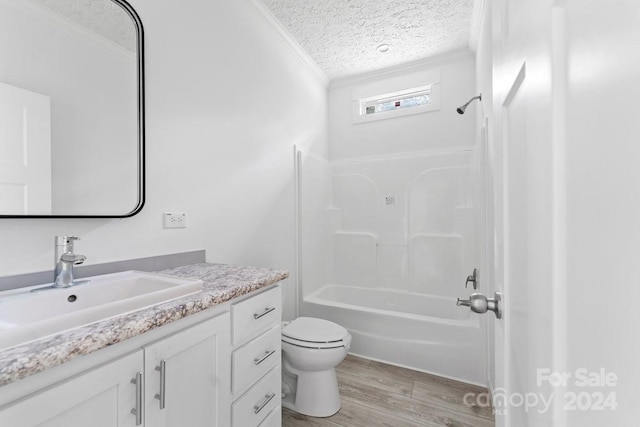 full bathroom featuring wood-type flooring,  shower combination, a textured ceiling, toilet, and vanity