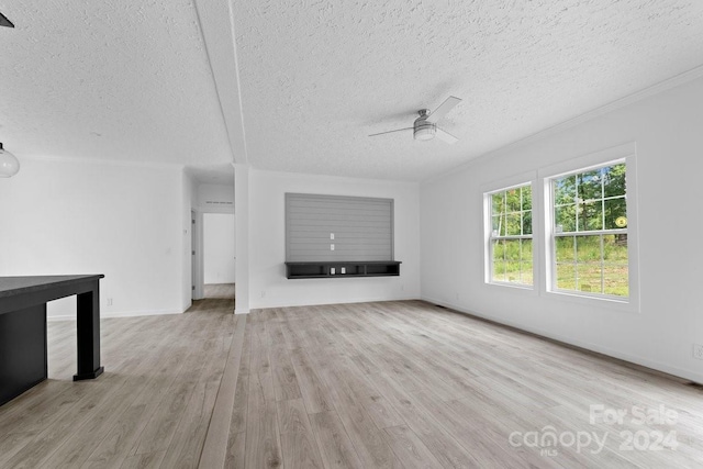 unfurnished living room with light hardwood / wood-style flooring, a textured ceiling, and ceiling fan