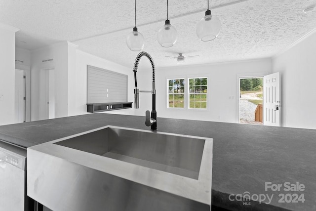 kitchen with ornamental molding, dishwasher, hanging light fixtures, and sink