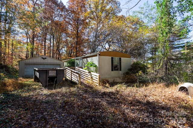 view of side of property with a garage and an outbuilding