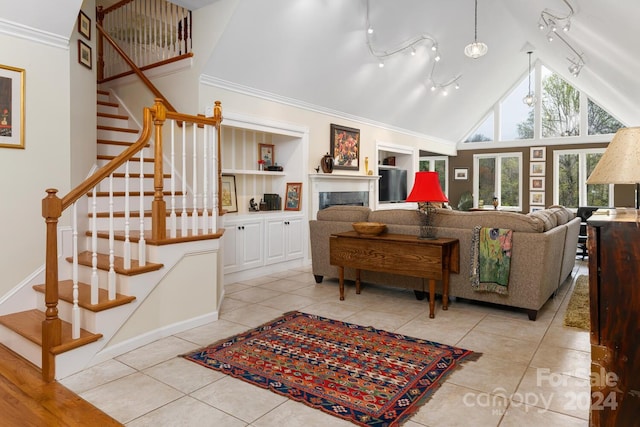 tiled living room featuring rail lighting, high vaulted ceiling, and crown molding