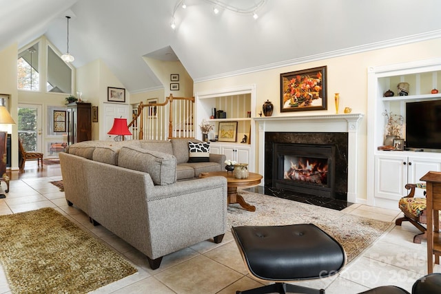 tiled living room with crown molding, track lighting, a fireplace, and high vaulted ceiling