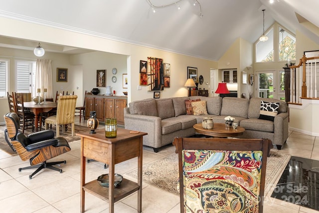 tiled living room featuring crown molding and high vaulted ceiling