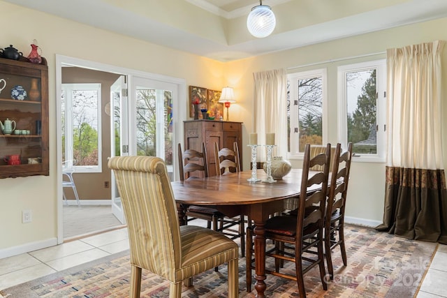 dining room featuring crown molding and light tile patterned floors