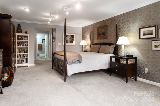 bedroom with crown molding, ensuite bath, track lighting, and light colored carpet