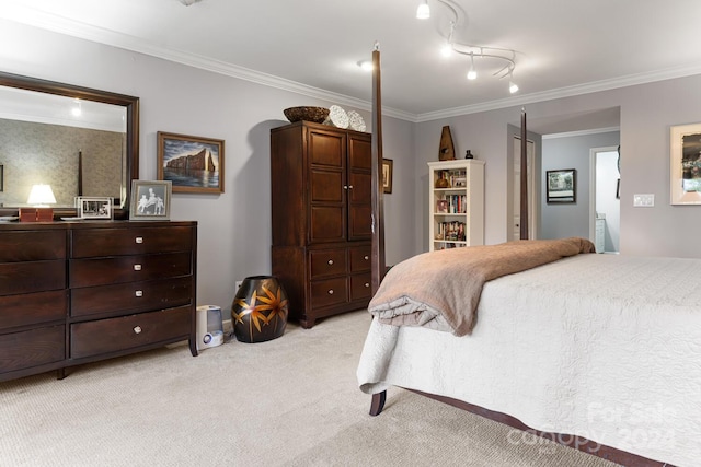 bedroom featuring crown molding, track lighting, and light colored carpet