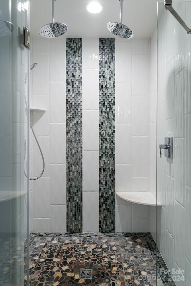 bathroom featuring a shower with door