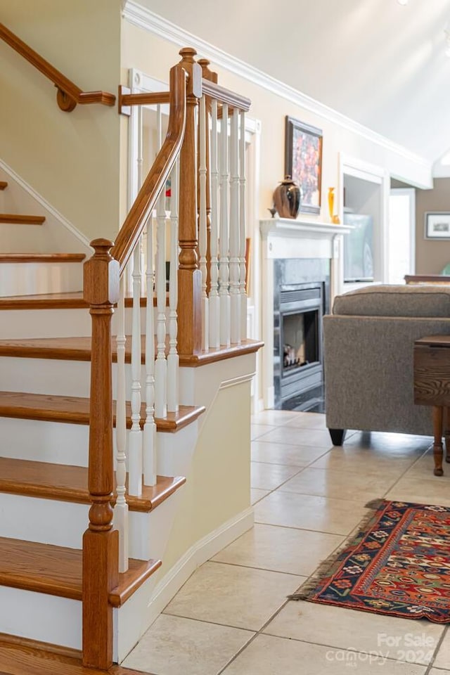 stairway featuring tile patterned floors and crown molding