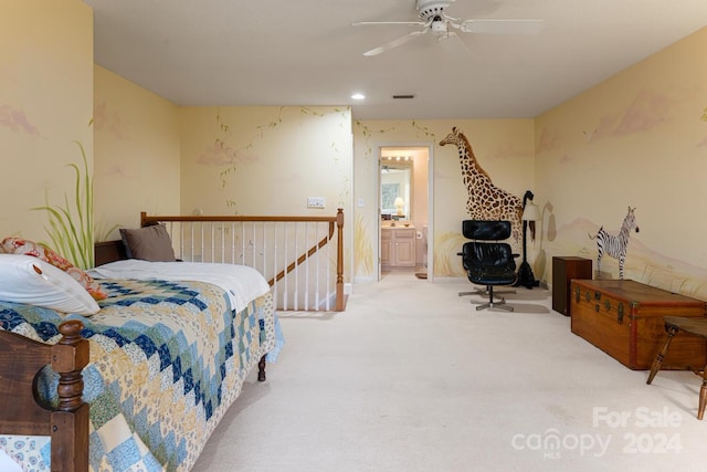 carpeted bedroom with ensuite bathroom and ceiling fan