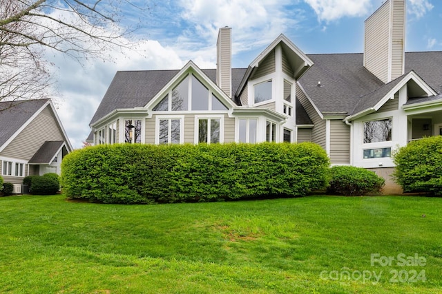 150 Overlook Dr, Flat Rock, NC 28731 - view of front of property featuring a chimney, a front lawn, and roof with shingles