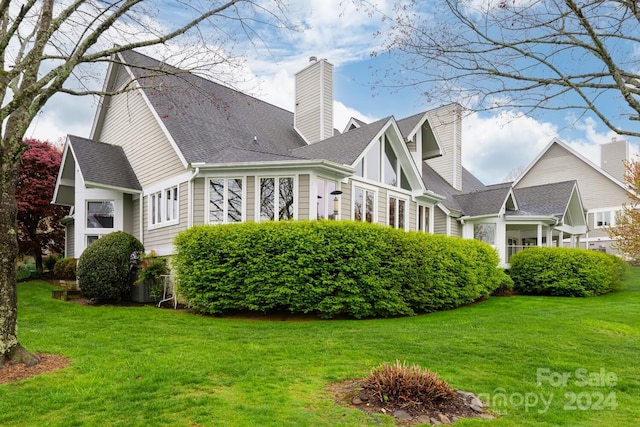 rear view of house with a lawn