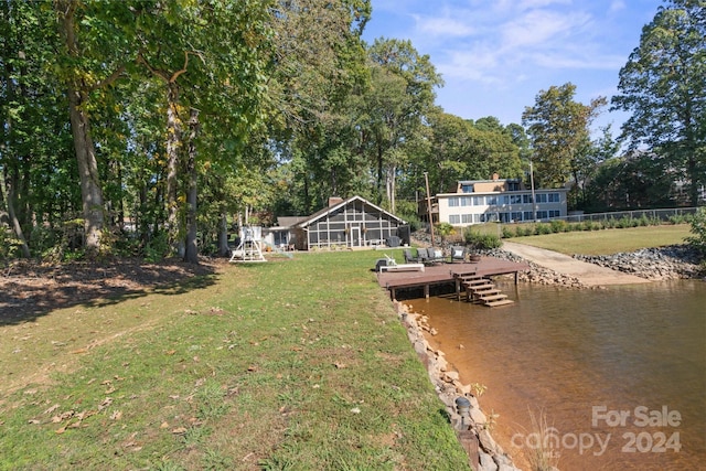 dock area with a yard and a water view