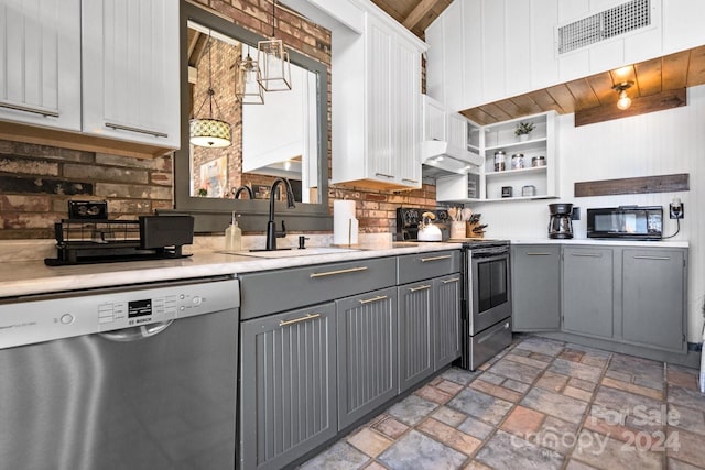 kitchen with sink, gray cabinetry, decorative light fixtures, and stainless steel appliances