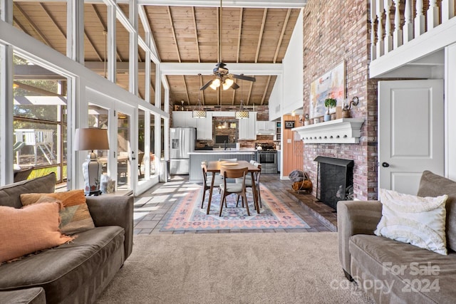 living room featuring beam ceiling, high vaulted ceiling, wooden ceiling, and ceiling fan