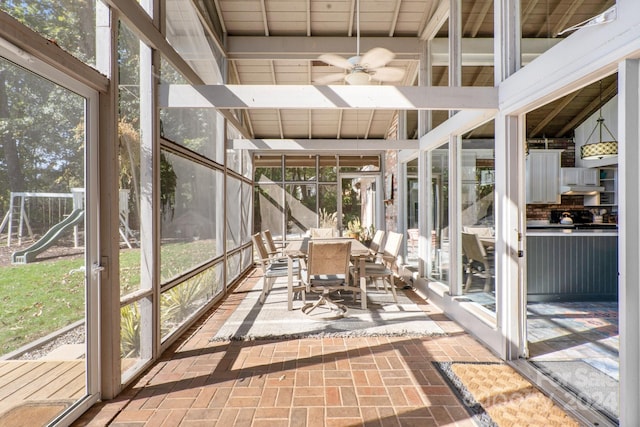 unfurnished sunroom featuring a healthy amount of sunlight and ceiling fan