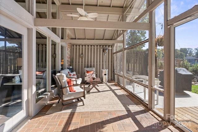 sunroom / solarium featuring ceiling fan