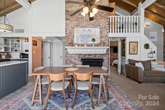 carpeted dining area with high vaulted ceiling, wooden ceiling, and beamed ceiling