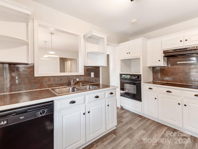 kitchen with black appliances, sink, white cabinetry, light hardwood / wood-style floors, and decorative backsplash