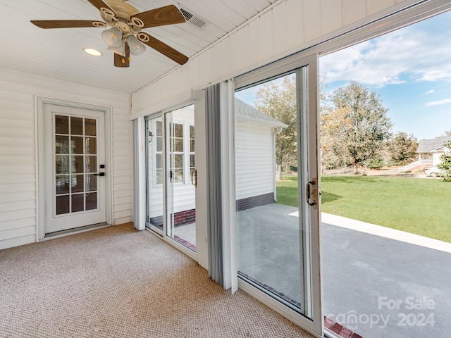 unfurnished sunroom featuring ceiling fan and wooden ceiling