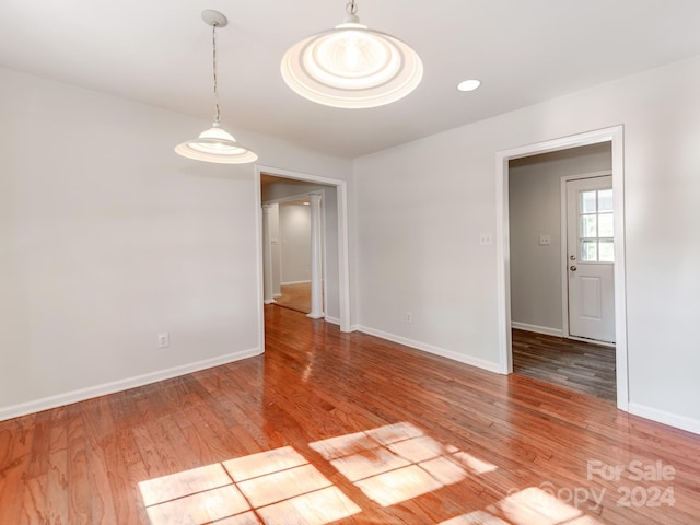 unfurnished room with light wood-type flooring