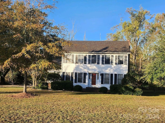 colonial home with a front lawn