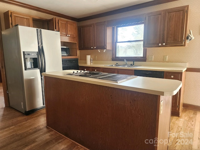 kitchen featuring sink, hardwood / wood-style floors, a center island, and stainless steel appliances