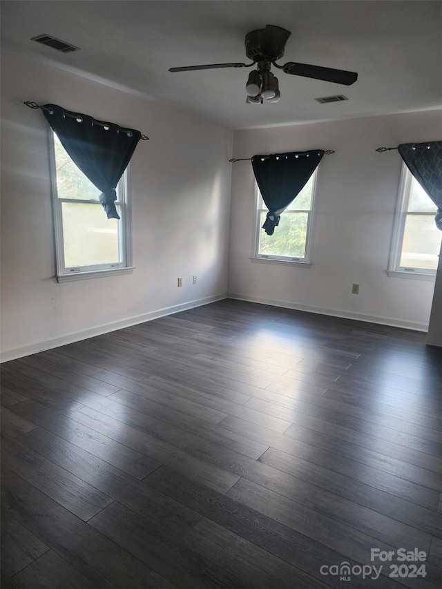 unfurnished room featuring ceiling fan and dark hardwood / wood-style flooring