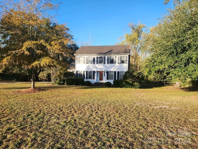 colonial-style house with a front lawn