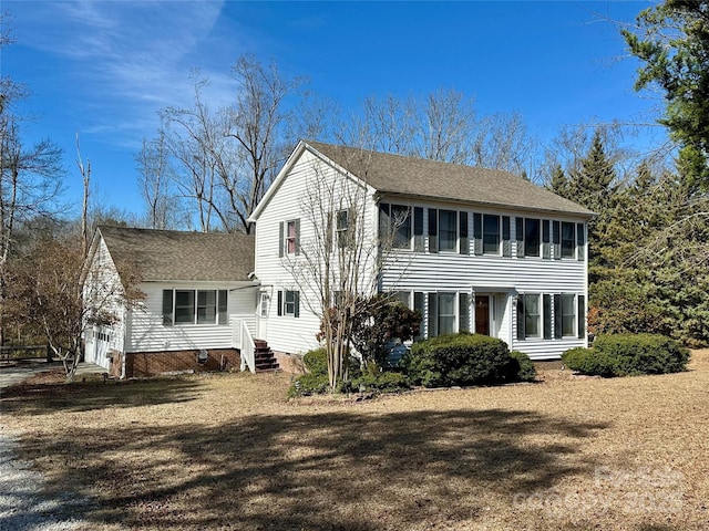 view of front of home with entry steps, roof with shingles, crawl space, and a front yard