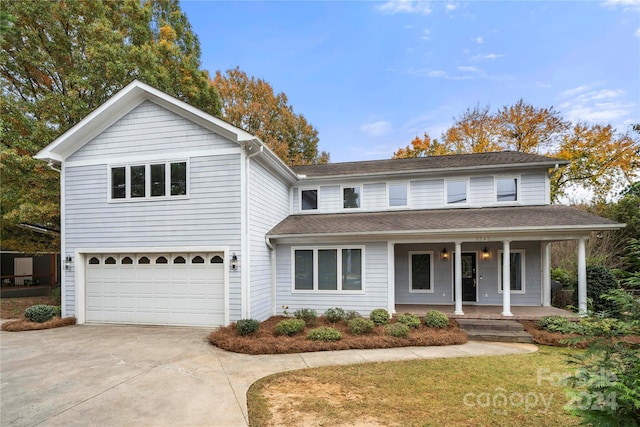 front of property featuring a porch and a garage