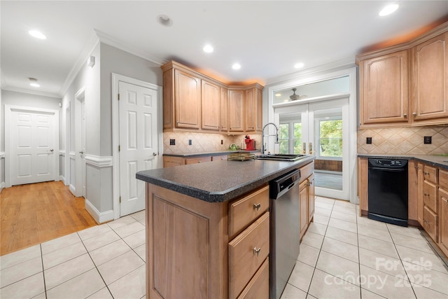 kitchen featuring sink, ornamental molding, stainless steel dishwasher, light tile patterned floors, and a center island with sink