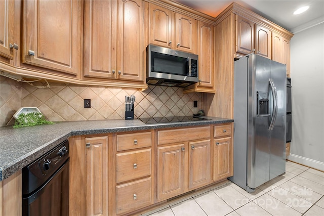 kitchen featuring crown molding, light tile patterned floors, decorative backsplash, and black appliances