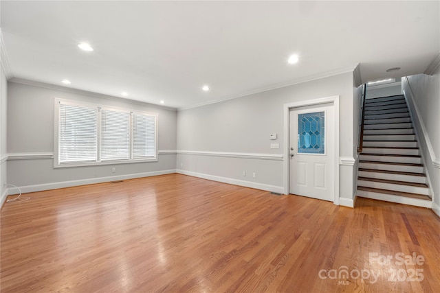 foyer entrance with crown molding and light wood-type flooring