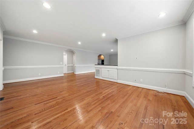 unfurnished living room featuring crown molding and light hardwood / wood-style floors