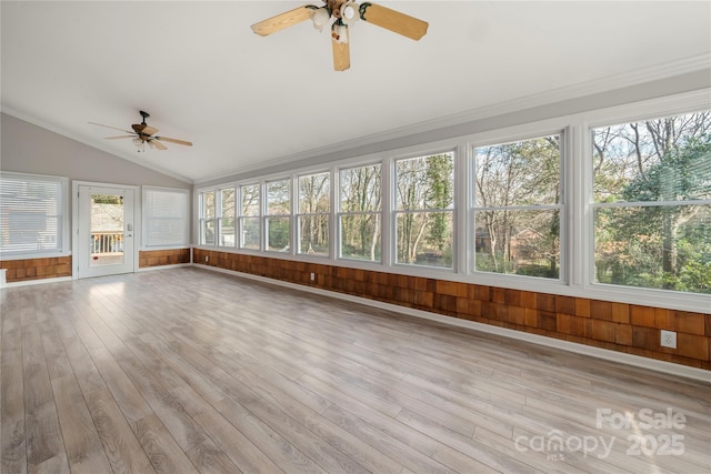 unfurnished sunroom with ceiling fan and lofted ceiling