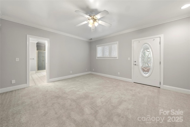 foyer with light carpet, crown molding, and ceiling fan