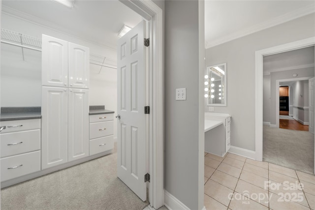 interior space featuring ornamental molding and light colored carpet