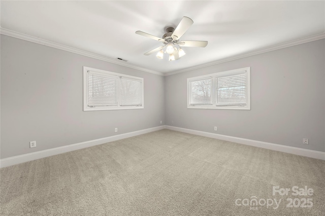 carpeted spare room featuring ornamental molding and ceiling fan