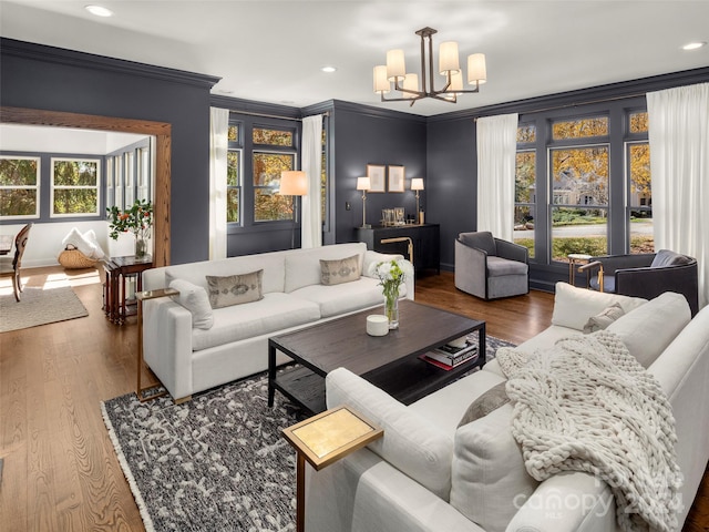 living room featuring a notable chandelier, hardwood / wood-style flooring, and a wealth of natural light