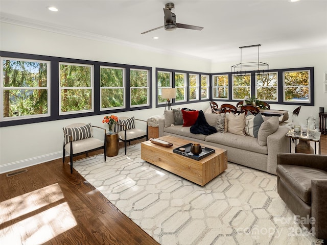 sunroom featuring ceiling fan with notable chandelier