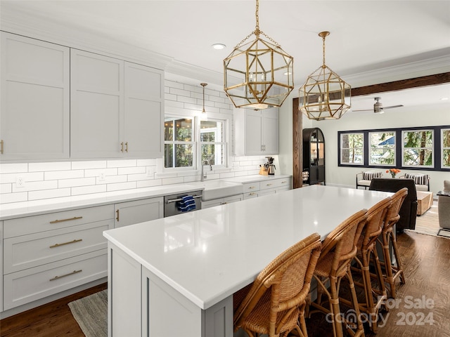 kitchen featuring a kitchen breakfast bar, decorative backsplash, a wealth of natural light, and a kitchen island